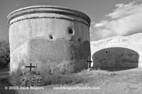 a black and white photo of an old stone wall
