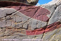 a rock with red and blue paint on it